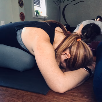 Close-up shot of a female yoga practitioner in pigeon's pose.